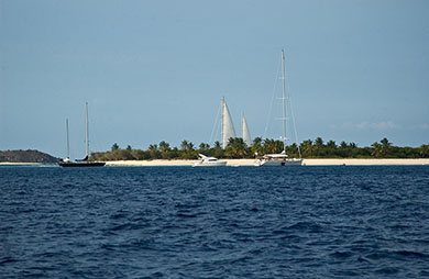 A small, sandy, reef island (with big sails!) (Sailing the British Virgin Islands)